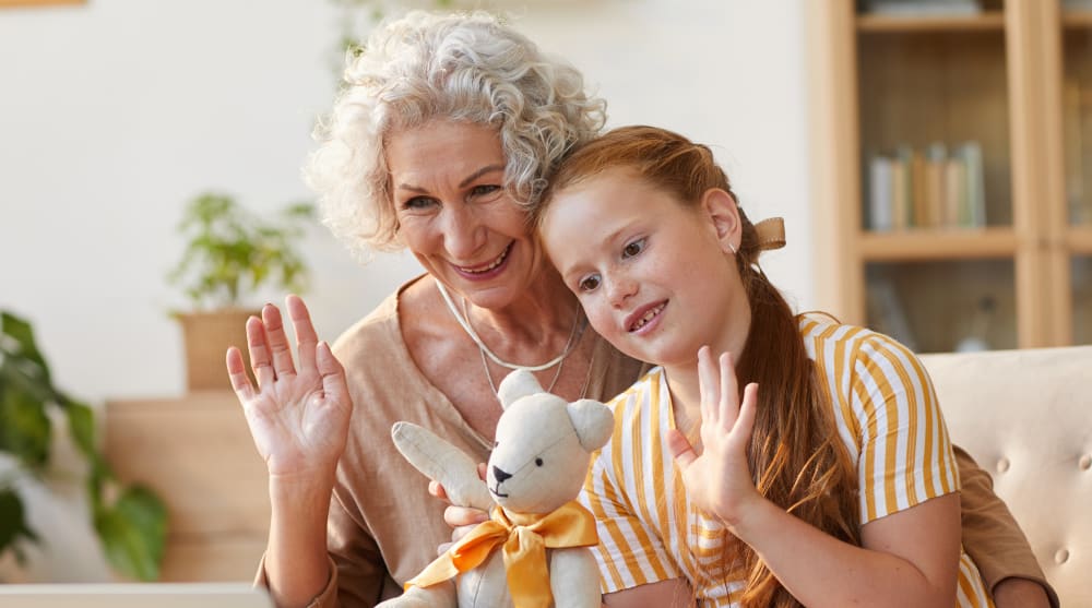 A young woman is standing at school holding a book bag and books.